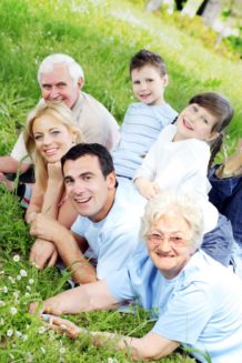 Multi-generational family outside on grass