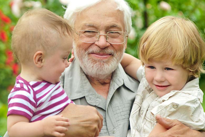 Grandfather holding young grandchildren