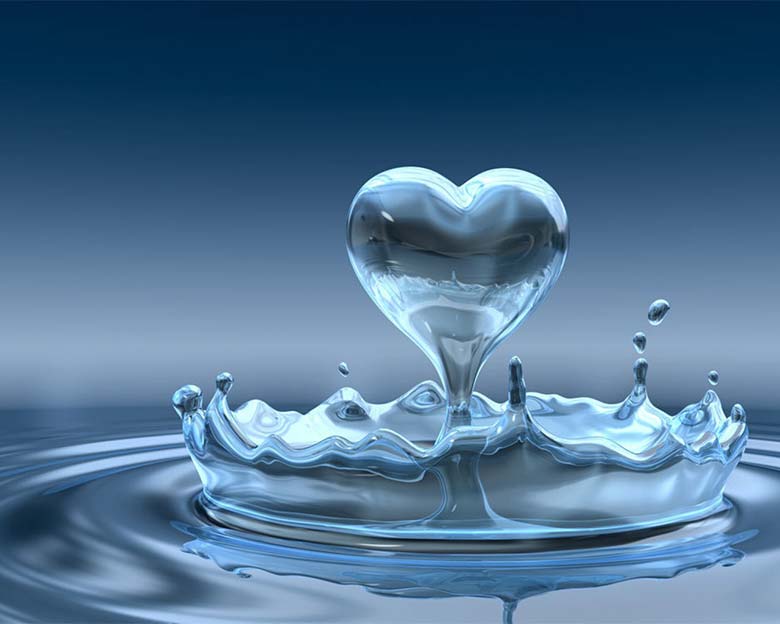 Water droplet bouncing up into a heart shape from lake surface