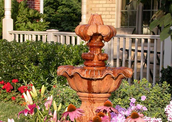 Fountain with flowers in front of home