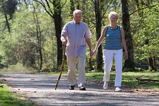 Elderly couple walking in park