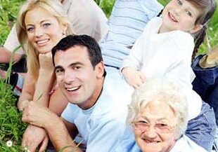 Family on grass smiling